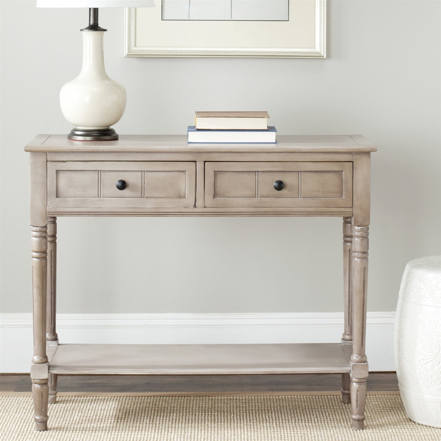 Wooden console table with two drawers and a shelf in a room setting.
